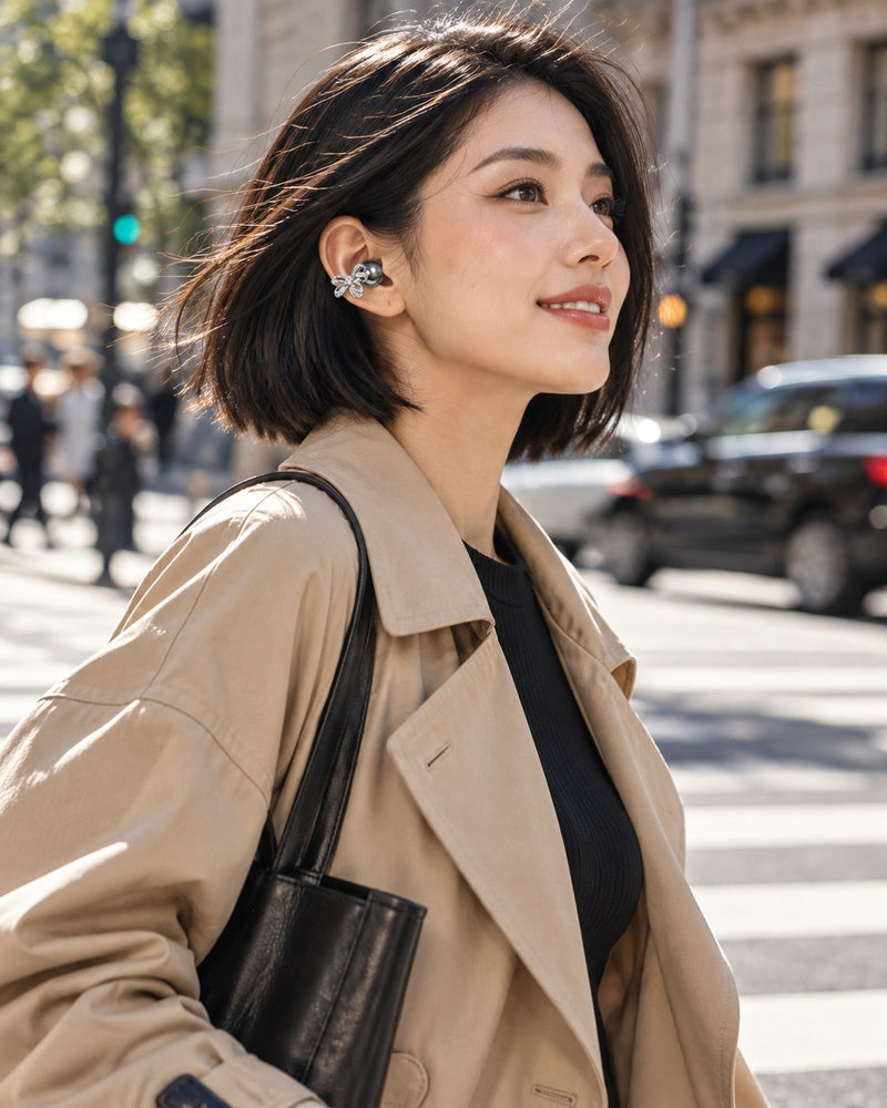 Woman walking in the city wearing a black bow clip-on earbud