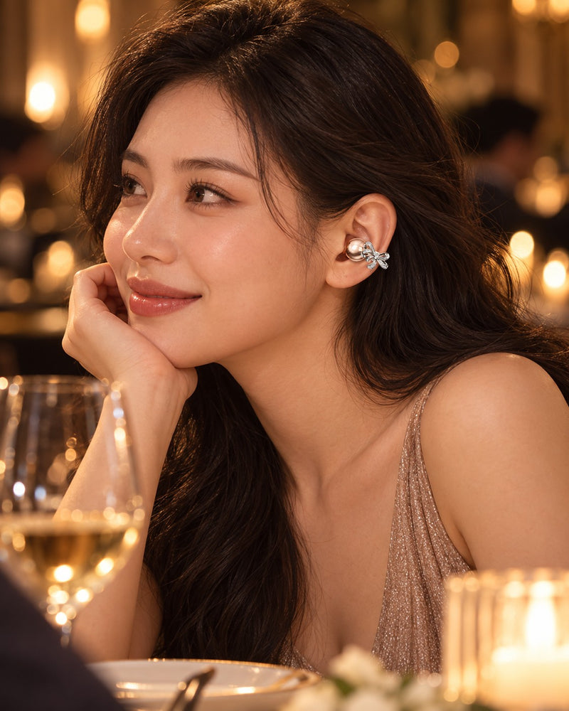 Woman at dinner wearing a rose gold bow clip-on earbud