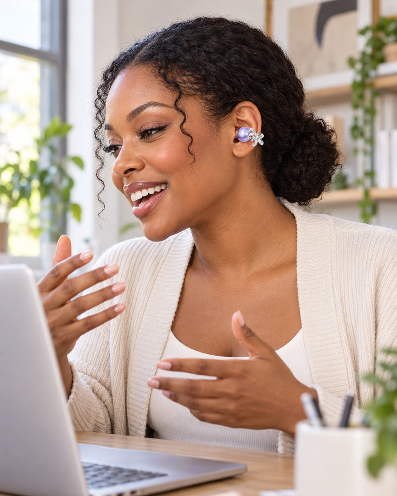 Woman on a video call wearing a lavender bow clip-on earbud